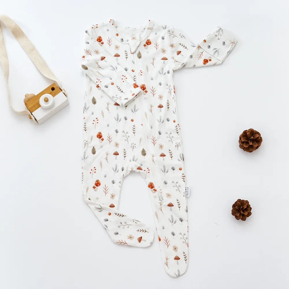 Unisex baby clothes, bamboo cotton romper, close-up of embroidered logo detailing, premium quality