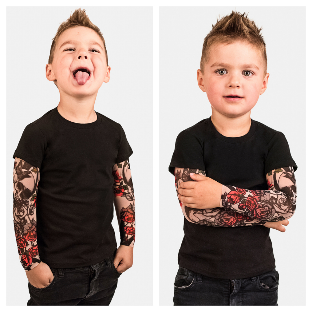 Close-up of rose print and tattoo sleeve detail on a baby romper, soft cotton playwear.
