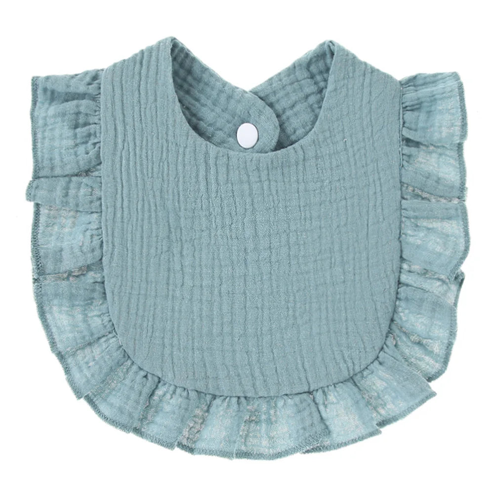 Close-up texture of cotton baby bib with ruffle lace, saliva towel