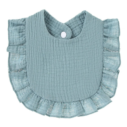 Close-up texture of cotton baby bib with ruffle lace, saliva towel