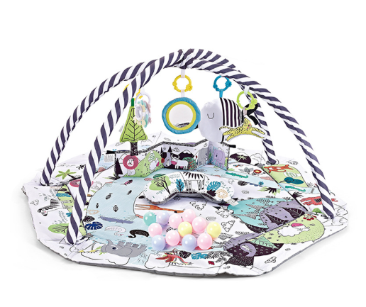 Happy baby reaching for a hanging toy on the baby gym playmat, promoting cognitive and physical development.