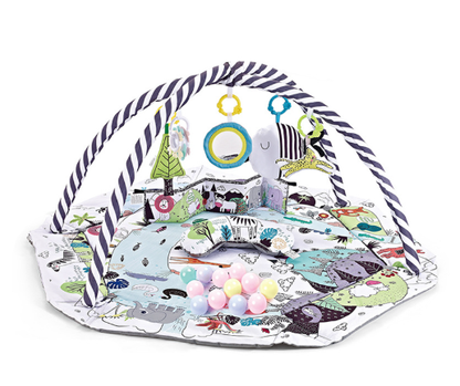 Happy baby reaching for a hanging toy on the baby gym playmat, promoting cognitive and physical development.