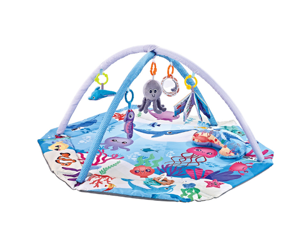 Close-up of a baby enjoying tummy time on the soft, washable playmat with various textures and colors.