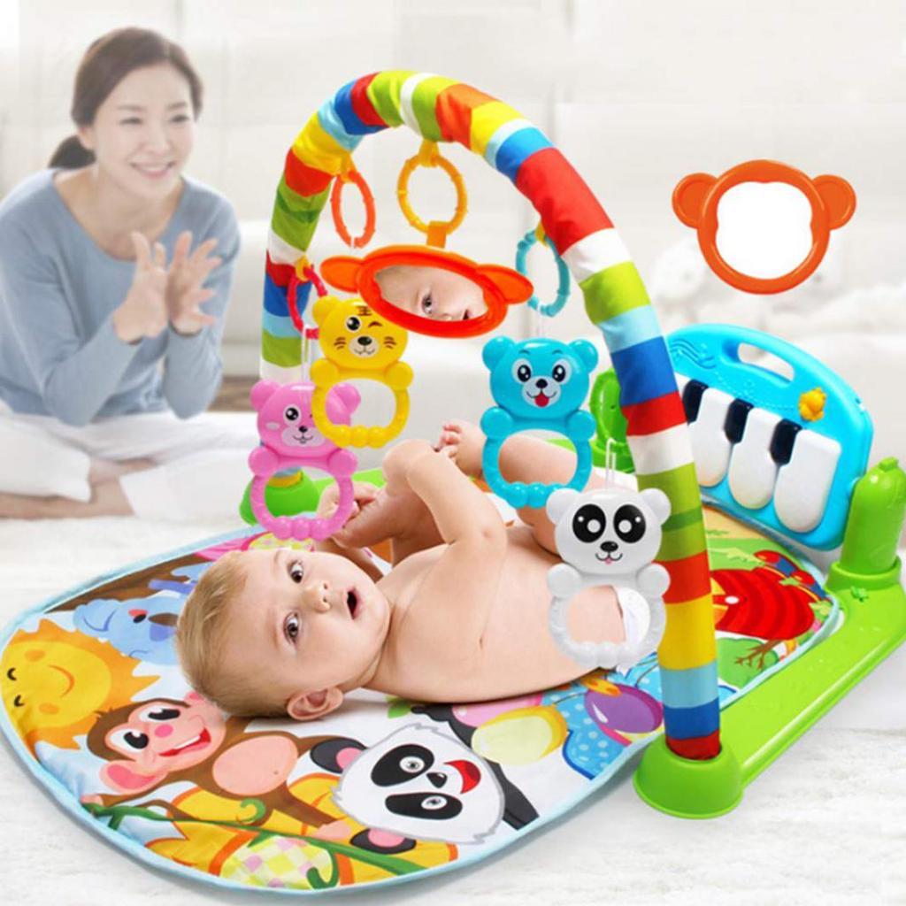 Developmental baby play mat featuring musical piano keys and colorful hanging sensory toys for infants