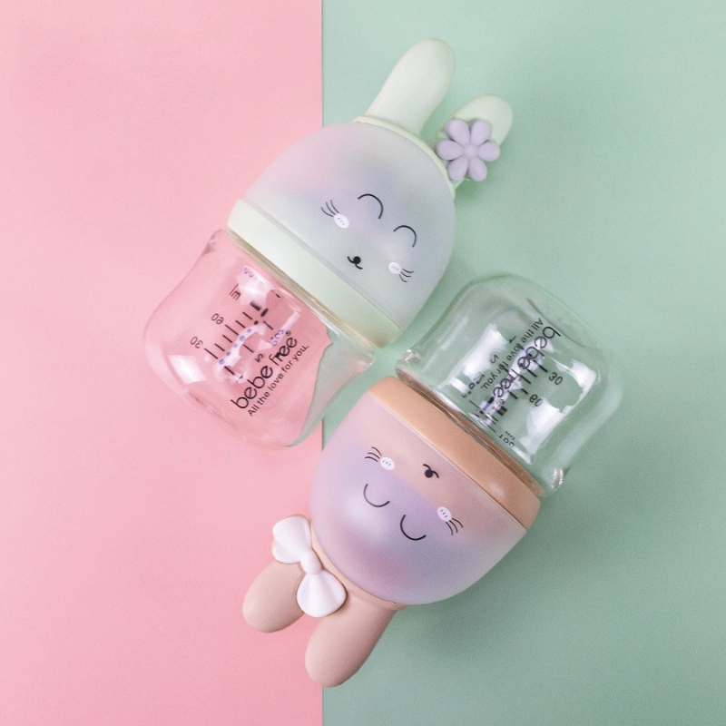 Baby's clear glass milk bottle with natural, breast-like nipple for safe infant feeding.