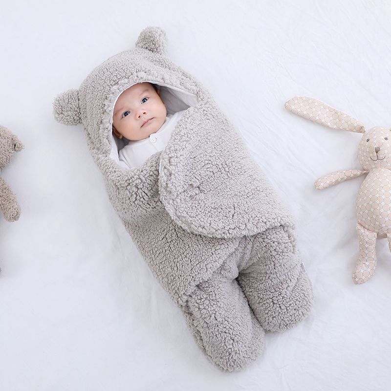 Newborn baby sleeping bag in soft cotton, featuring a cute bear hoodie and secure swaddle design