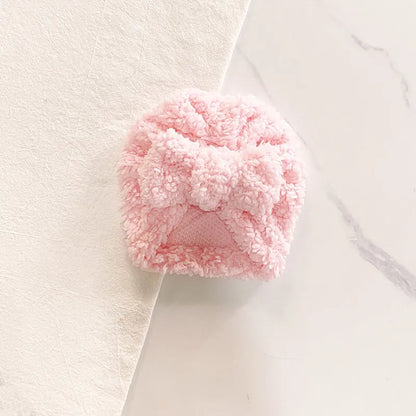 Baby's cozy knitted beanie hat with a small pom-pom detail, adding charm to winter wear.