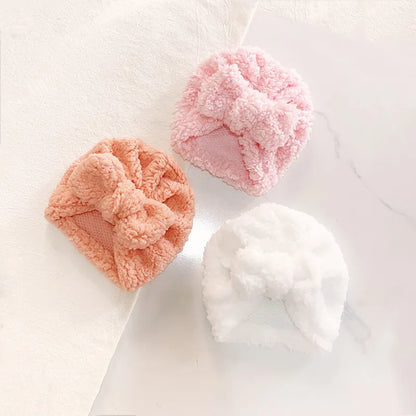 Newborn baby wearing an ultra-soft knitted beanie hat, perfectly sized for infant warmth.
