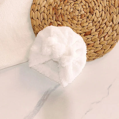 Eco-friendly knitted beanie hat, crafted from recycled yarns, cozy and sustainable baby wear.