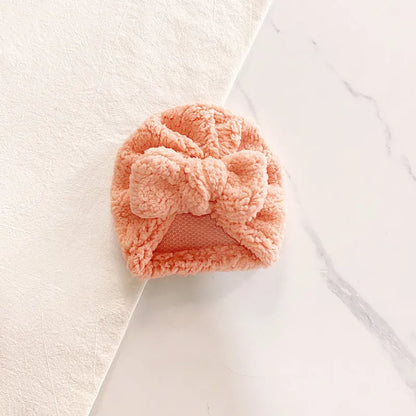 Baby's first winter hat: a simple, soft knitted beanie, easy to put on and comfortable.