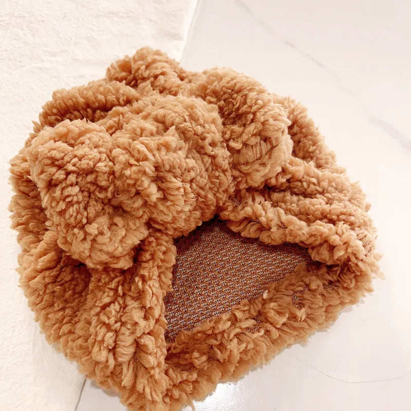 Warm baby accessories: a light pink knitted beanie hat, soft and cozy for infants.