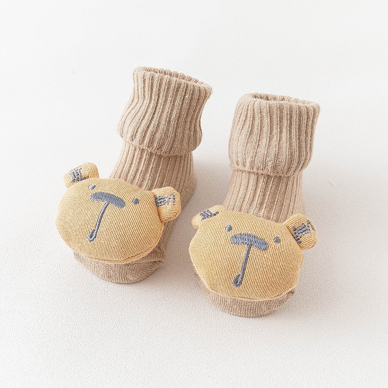 Assorted animal print anti-slip long socks for infants, offering comfort and grip.