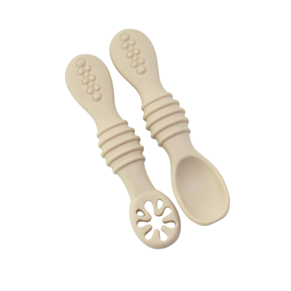 Baby feeding essentials: ergonomic soft silicone spoon for new eaters learning self-feeding techniques.