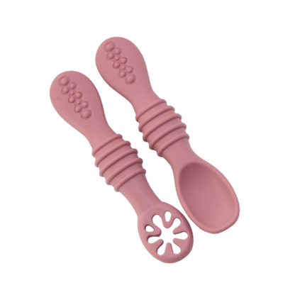 Close-up of a baby's first self-feeding silicone spoon, ideal for soft, gentle mealtime exploration.