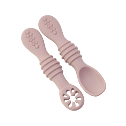 Two gentle silicone baby spoons designed for easy grip, promoting independent self-feeding skills.