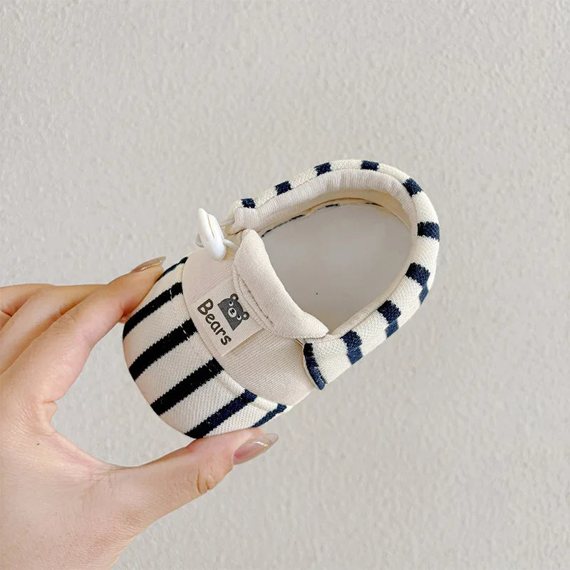 Cute infant shoes with anti-slip bottom, providing stability for first steps.