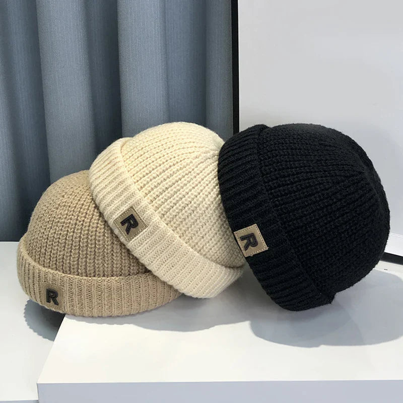 Baby's knitted melon cap with 'R' letter, soft polyester, perfect for toddler warmth & style.