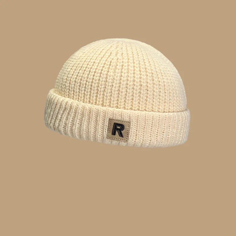 Polyester 'R' letter baby hat, a comfortable and cute knitted cap for infant fashion.