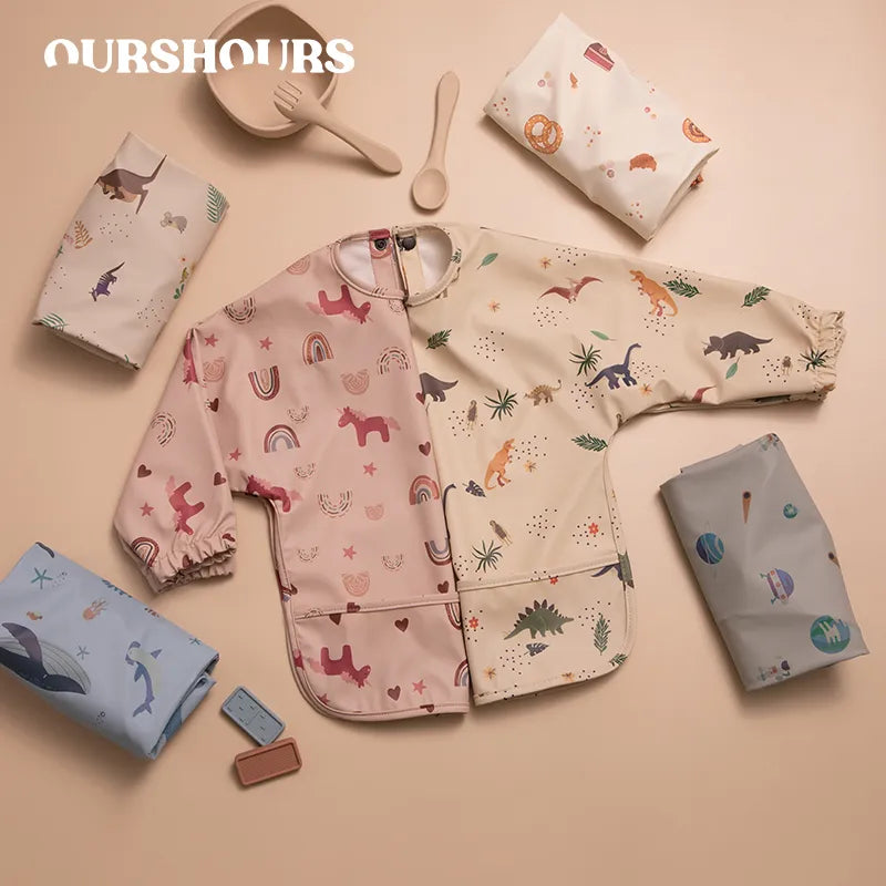 Adjustable long sleeve baby bib with cute animal print, ideal for toddler feeding and weaning