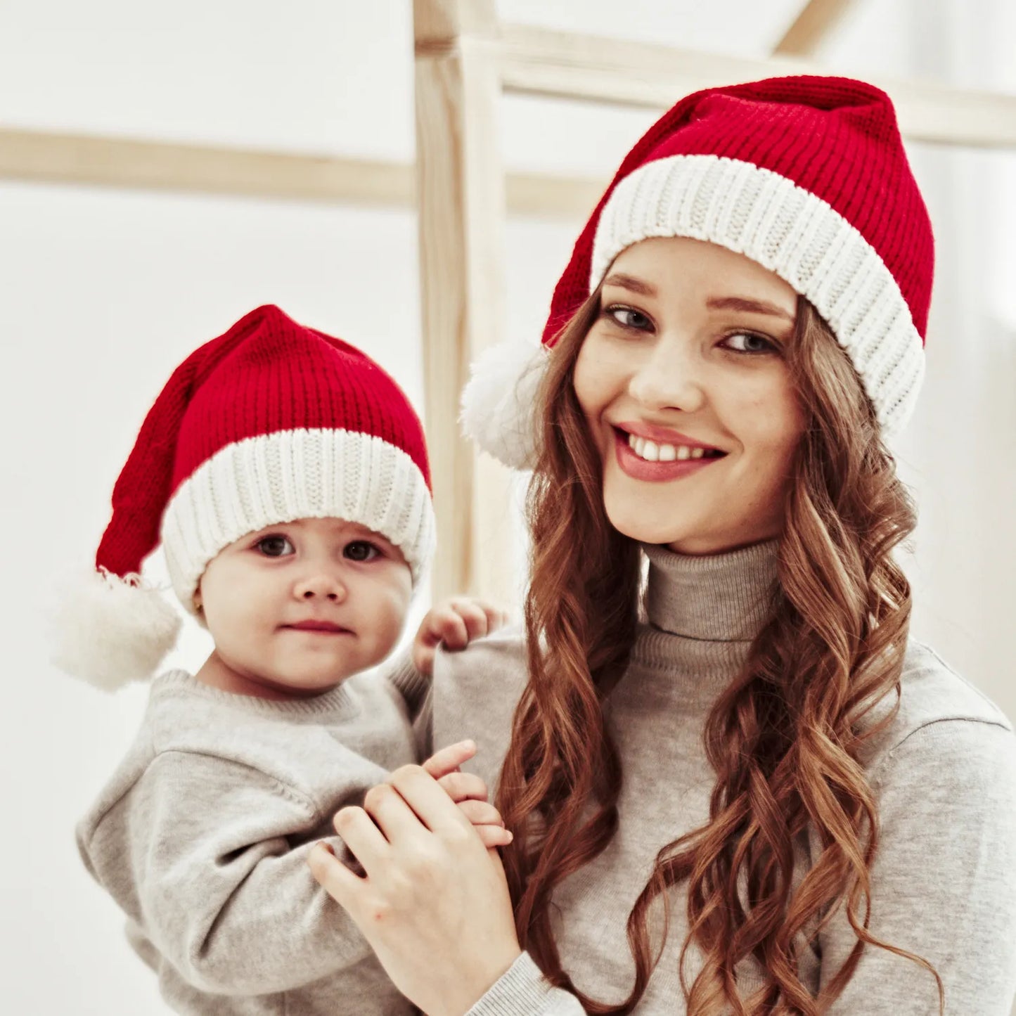 Infant wearing a soft red and white Cozy Christmas Santa Hat, ideal for baby's first Christmas.