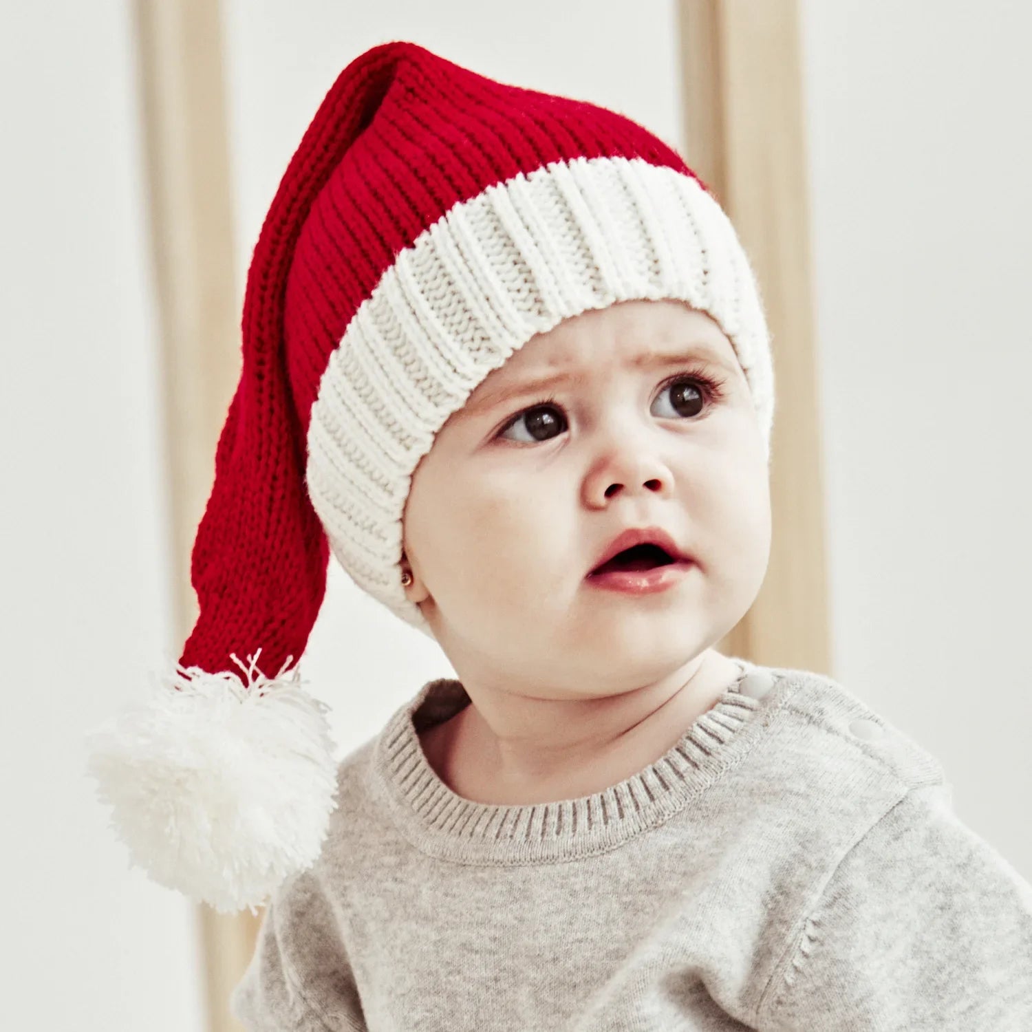 Close-up of a Baby's Cozy Christmas Santa Hat, featuring a plush red fabric and white trim.