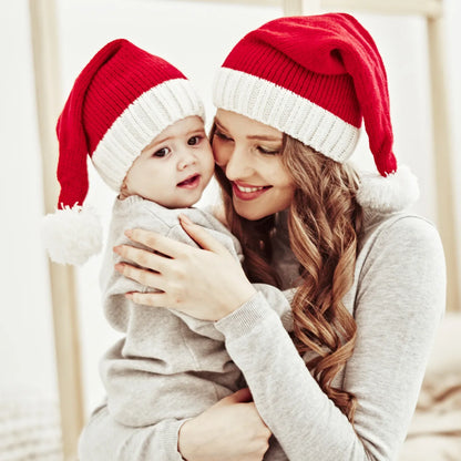 Warm red Baby's Cozy Christmas Santa Hat with white pom-pom, a charming baby winter hat accessory.