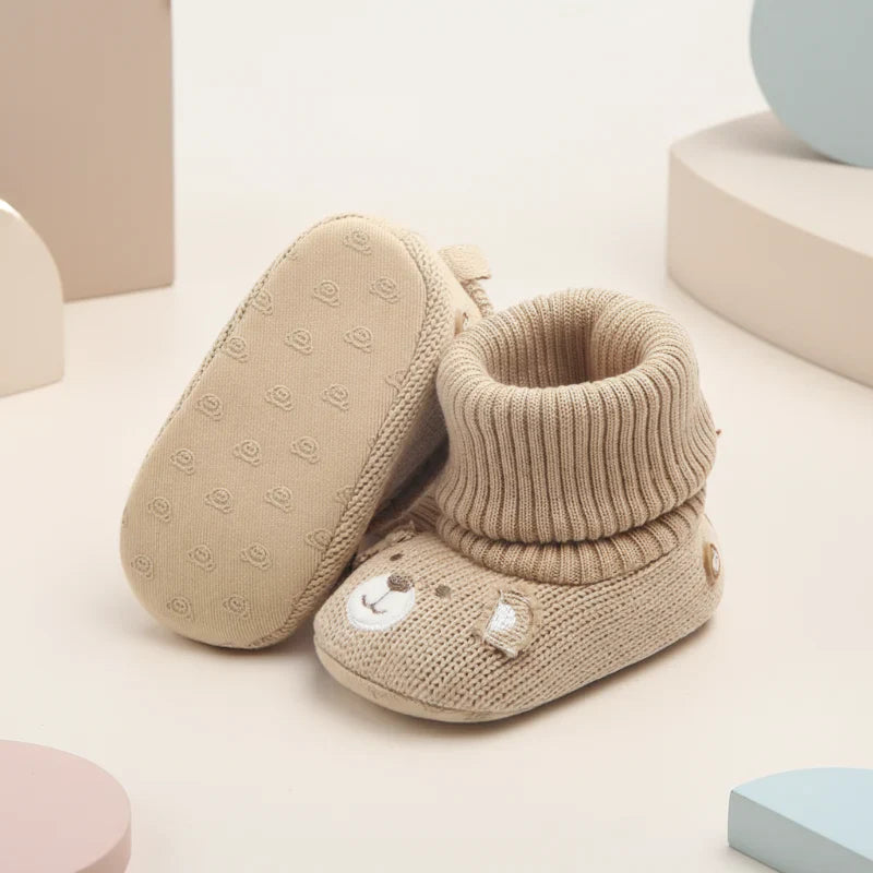 Toddler's dark blue soft winter booties, designed for warmth and non-slip safety.