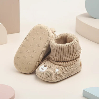 Toddler's dark blue soft winter booties, designed for warmth and non-slip safety.