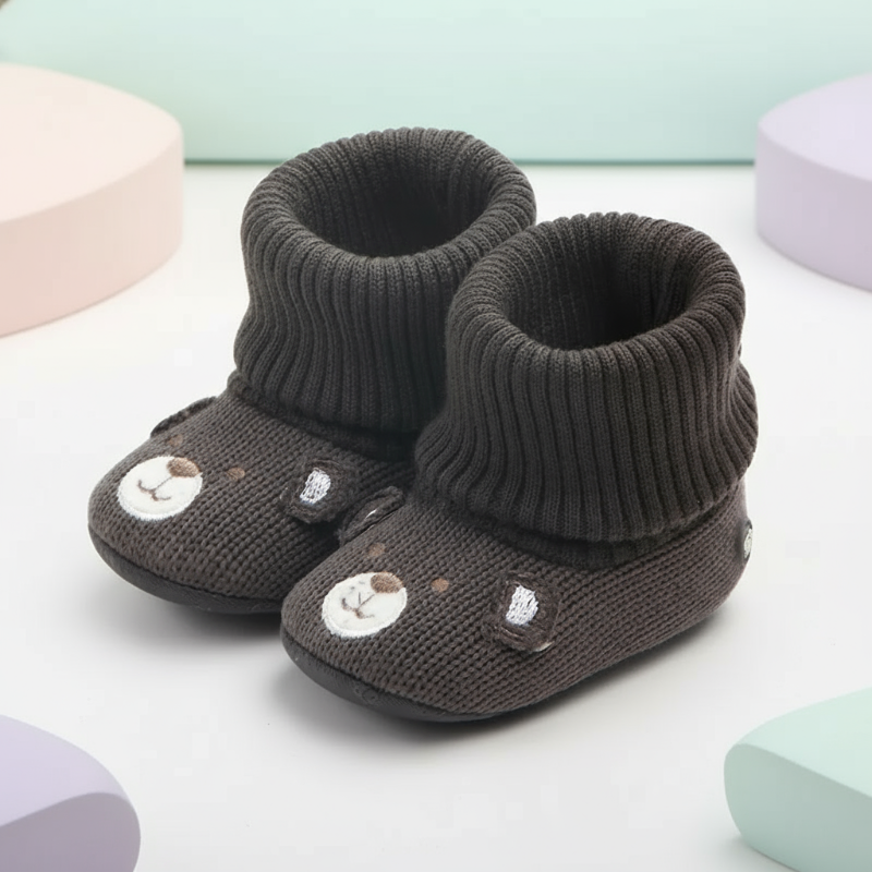 Soft, comfortable newborn booties in white, offering warmth and a secure non-slip sole.
