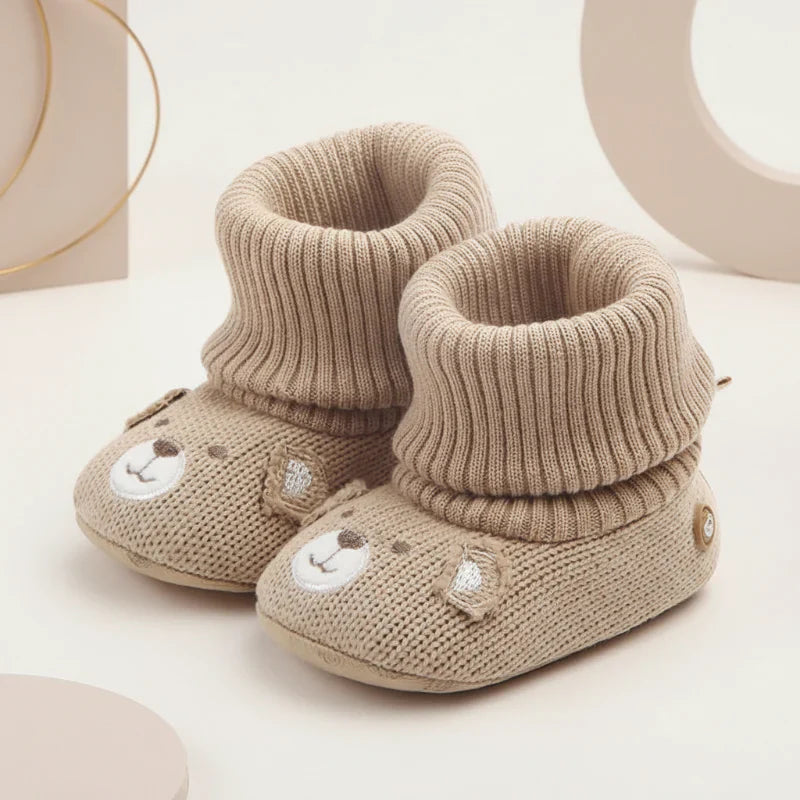 Collection of colorful baby winter booties, soft, warm, and non-slip for infants.