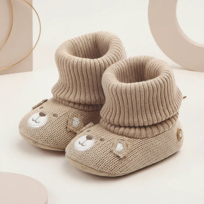 Collection of colorful baby winter booties, soft, warm, and non-slip for infants.