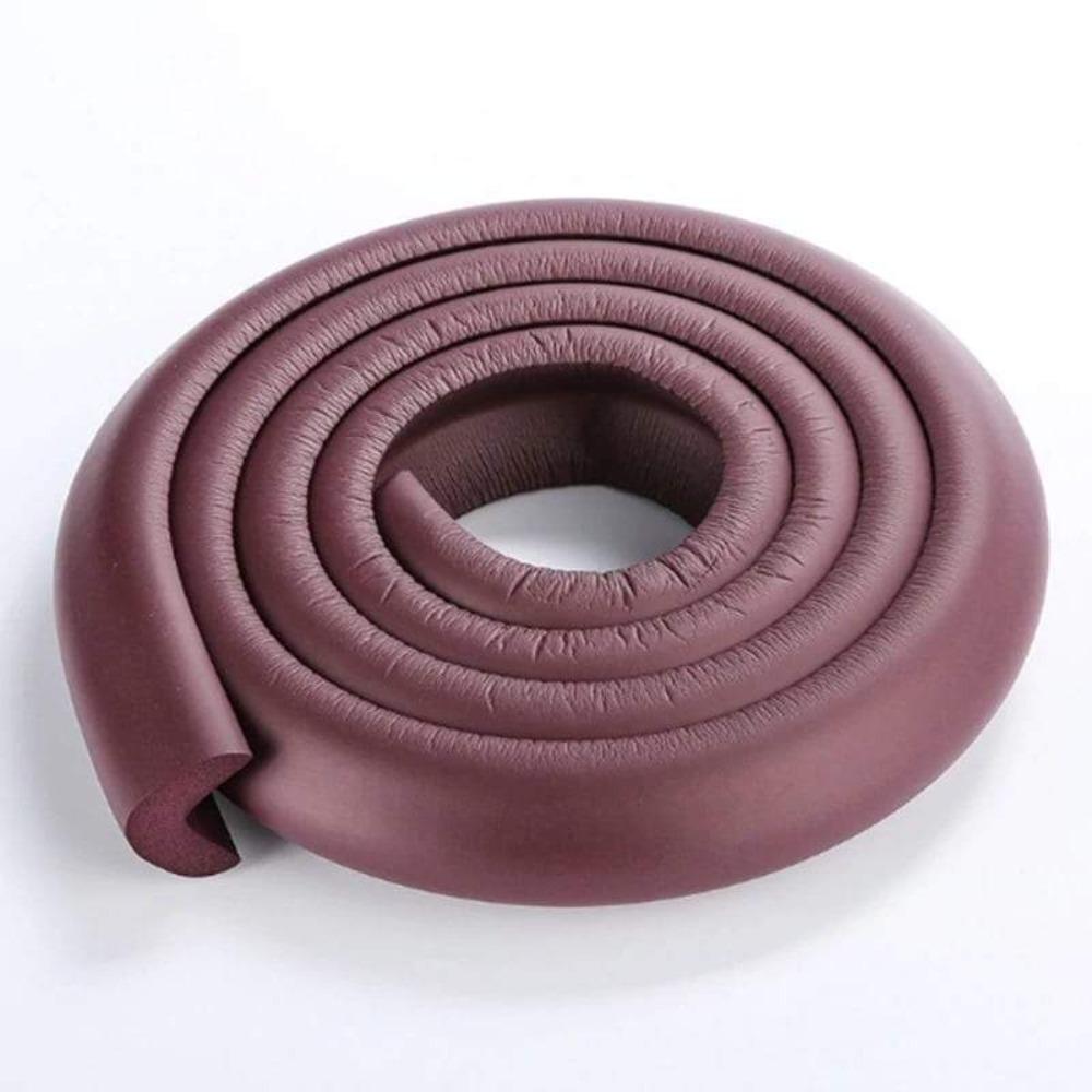 Long foam edge guard applied to a coffee table for comprehensive baby and toddler safety.