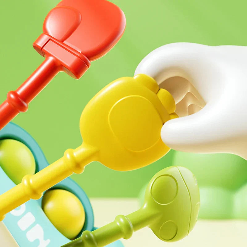 Infant teething toy with multiple silicone strings, perfect for developmental play and sensory stimulation.