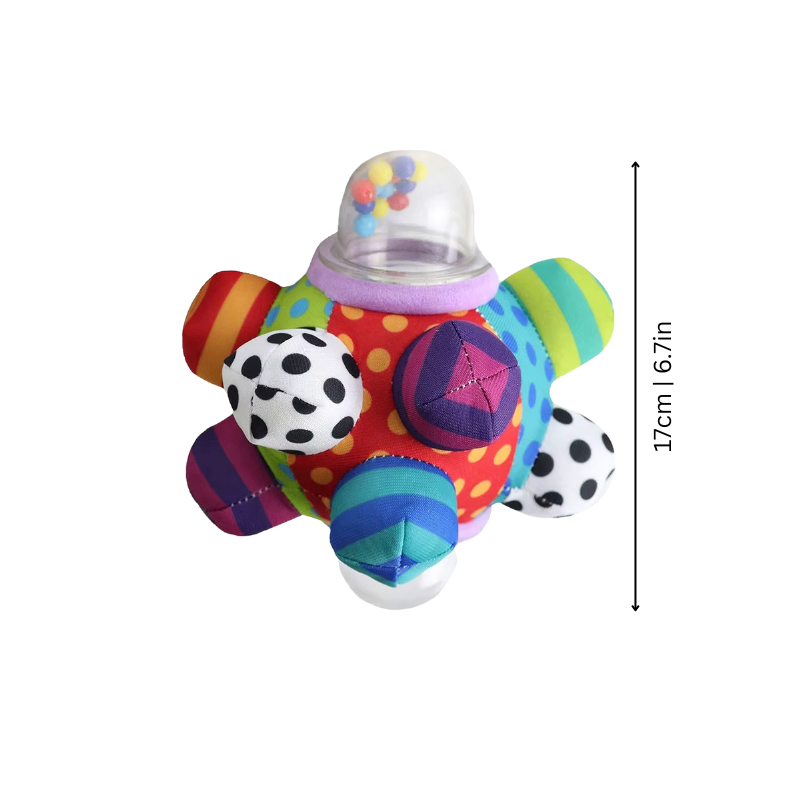 Close-up of a baby grasping a soft, colorful sensory rattle toy, promoting infant developmental skills