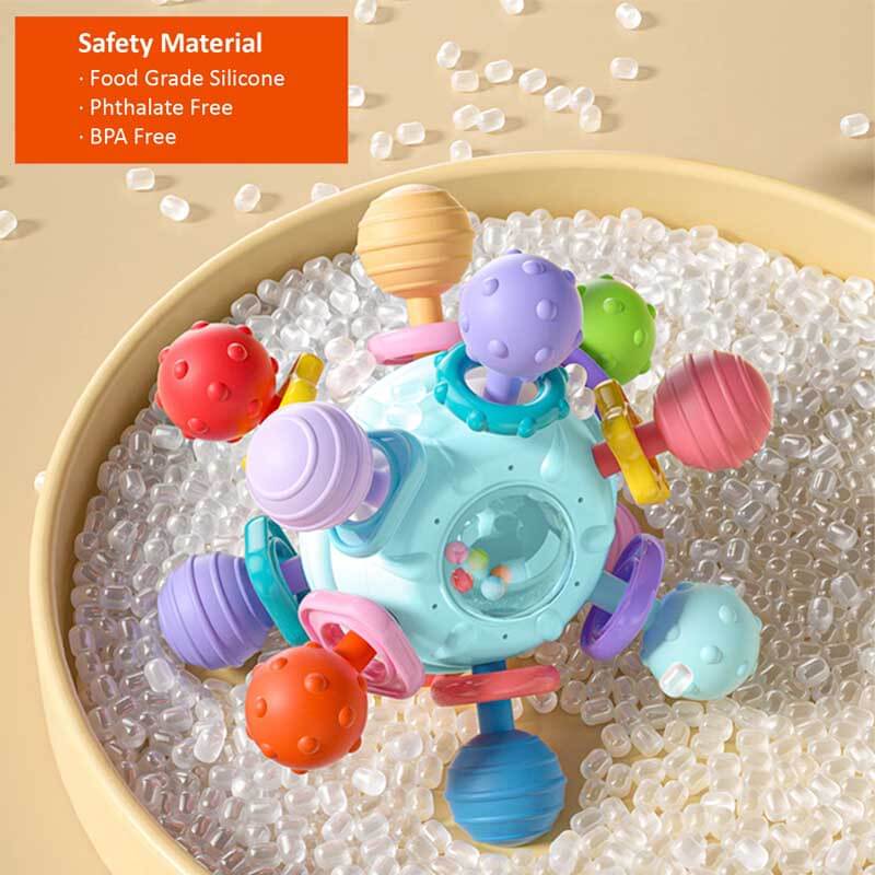 Close-up of a baby teether rattle, soft silicone loops and wooden rings, developmental Montessori toy