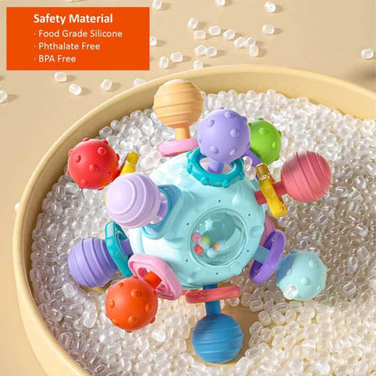 Close-up of a baby teether rattle, soft silicone loops and wooden rings, developmental Montessori toy