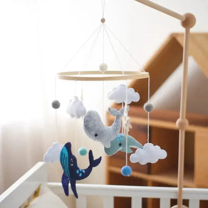 Close-up of a Baby Sensory Wooden Mobile showcasing the detailed wooden rings and soft felt clouds, crib mobile