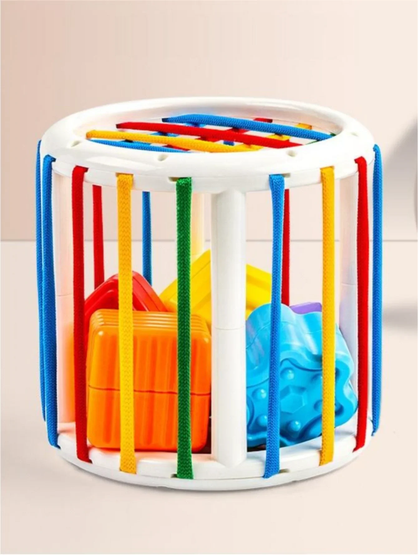 Close-up of a square block fitting into the Baby Shape Sorter Cube, motor skills