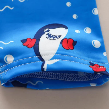 Fun Baby Shark kids pool suit. Comfortable blue infant bathing suit with cute shark design, perfect for water play.
