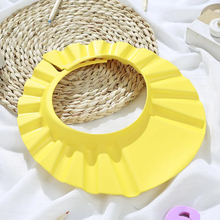 Infant ear defender shower cap. Lightweight and secure for peaceful, mess-free baby bath time.