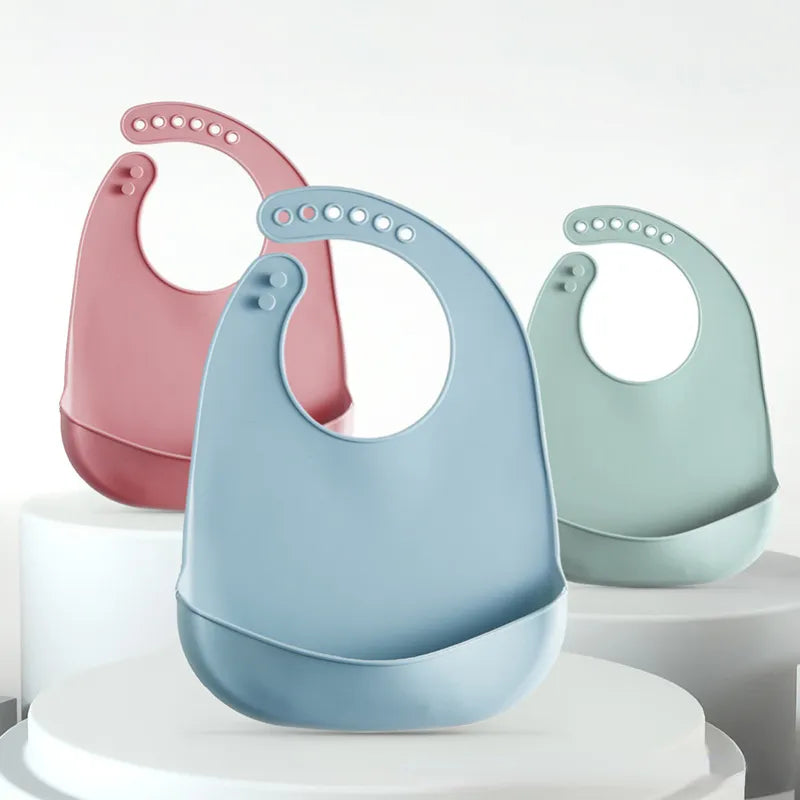 Easy-clean toddler silicone bib, solid color, with secure, adjustable snaps.