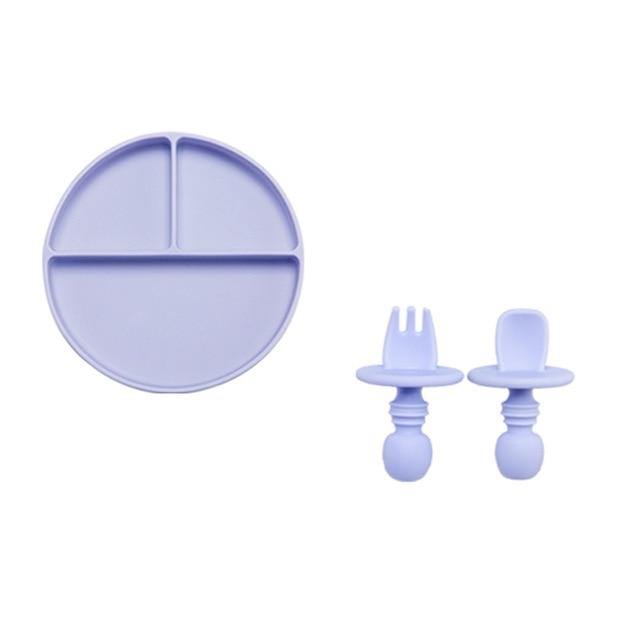 Durable silicone kids plate in orange, with suction base and matching baby-friendly utensils