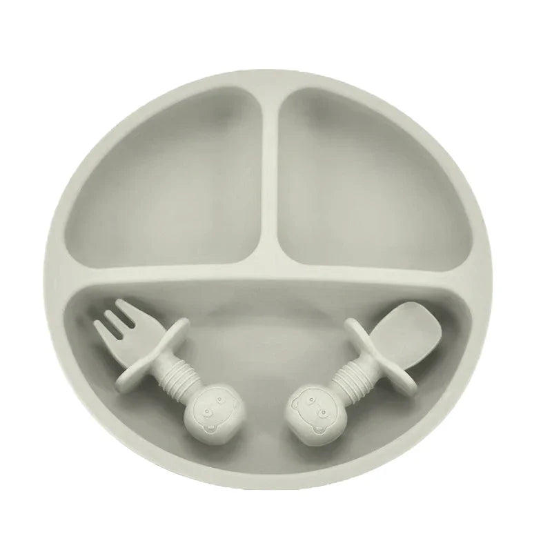 Detailed view of a durable silicone divided plate, spoon, and fork in yellow for baby led weaning