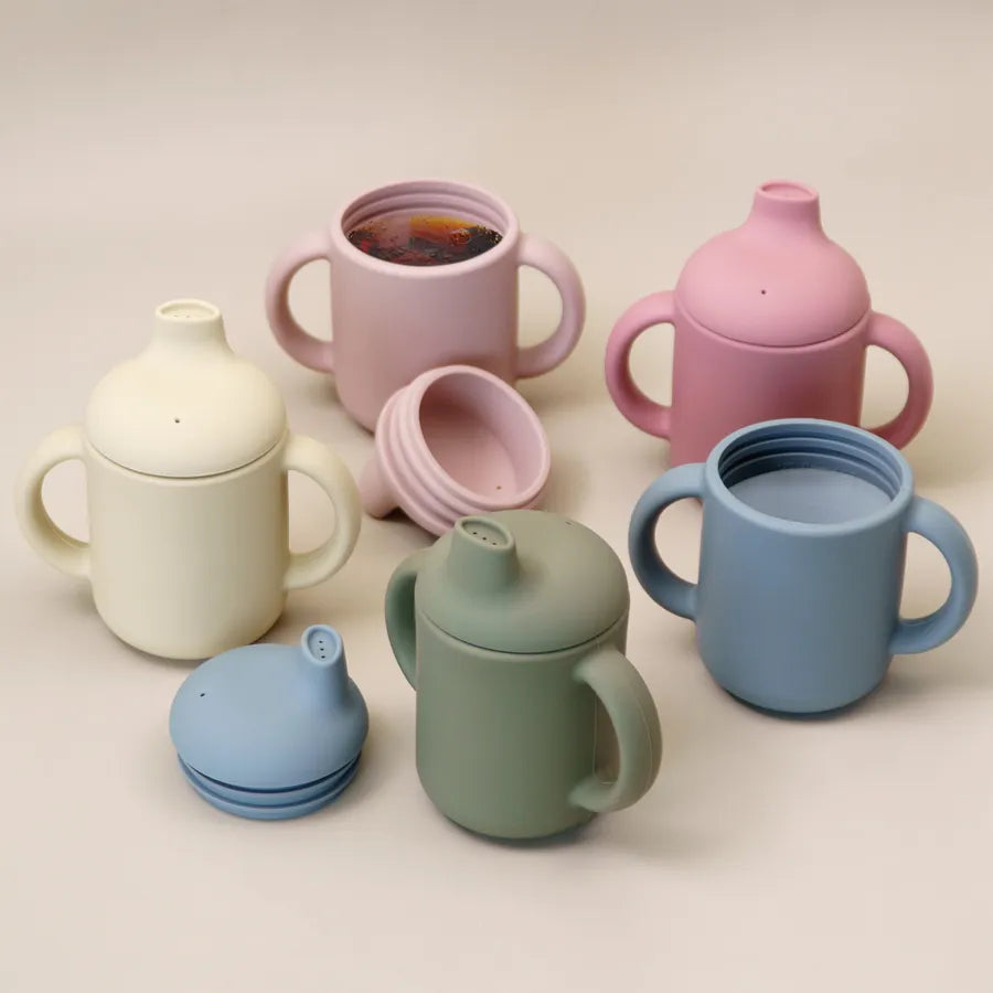 Baby silicone learning cup with easy-grip handle, perfect for toddlers and infants learning to drink.