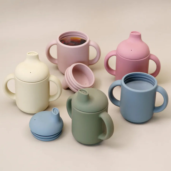 Baby silicone learning cup with easy-grip handle, perfect for toddlers and infants learning to drink.