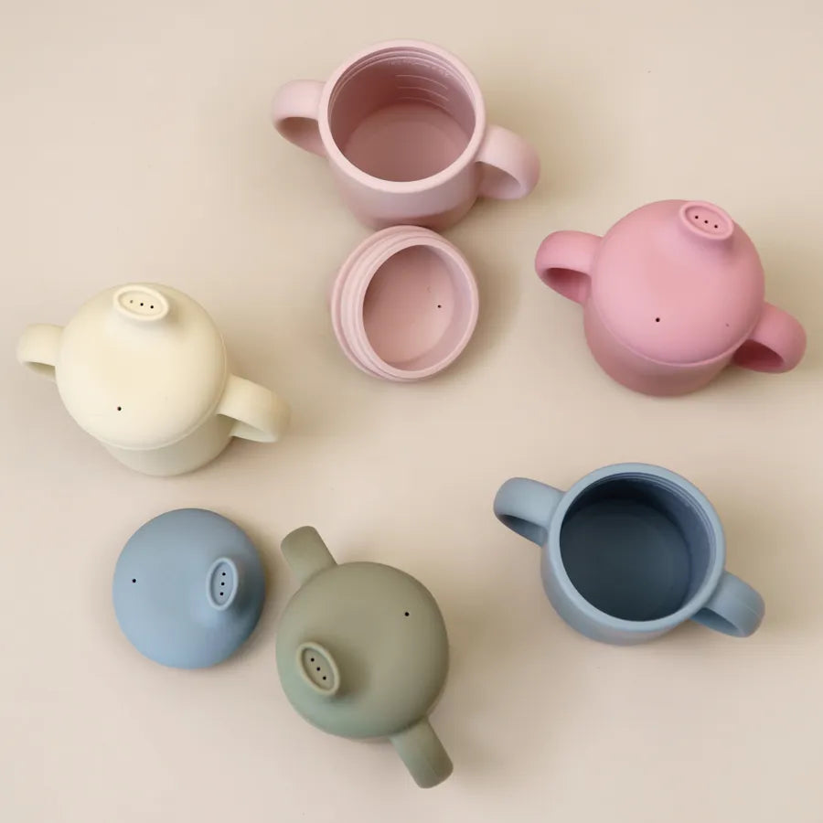 Toddler learning cup made from durable silicone, featuring two easy-grip handles.