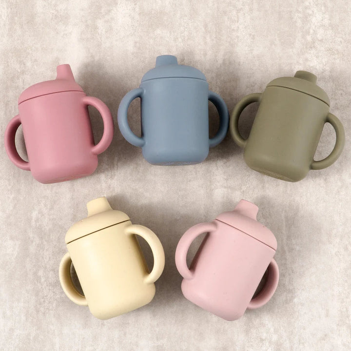 Colorful silicone sippy cup for babies, designed for easy drinking and spill prevention.