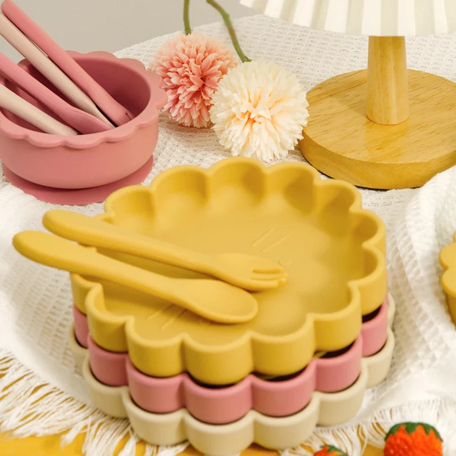Close-up of a yellow silicone lion plate with suction base for toddler feeding