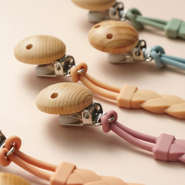 Secure silicone pacifier holder, attaches to clothes & blankets, BPA-free material.