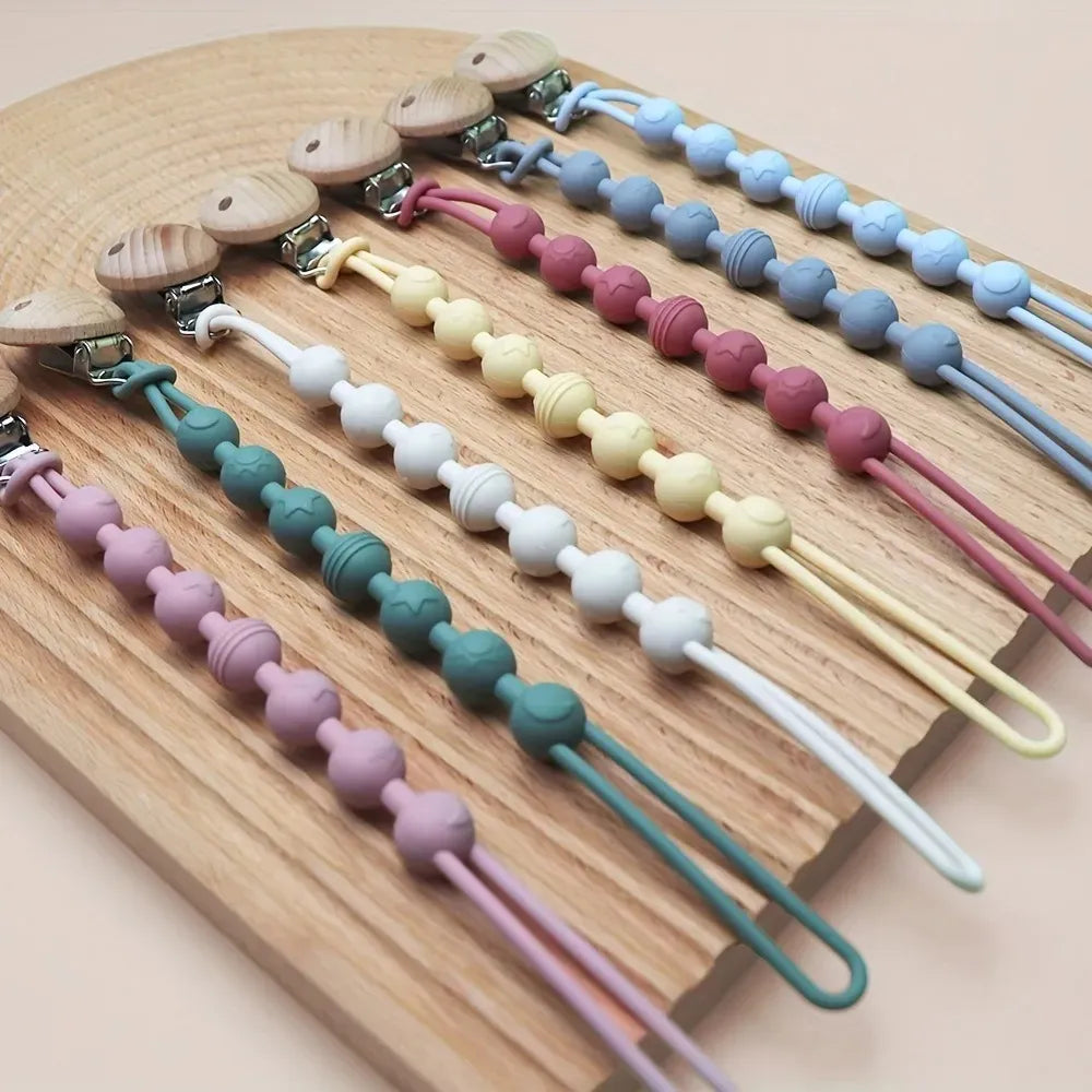 Baby silicone pacifier clip with teether, ideal for teething relief and keeping pacifier secure.